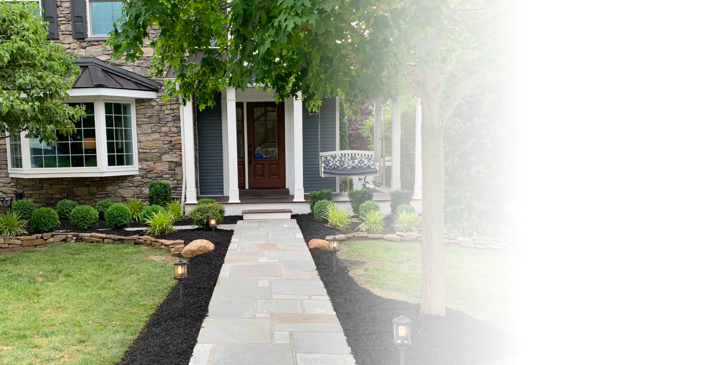 stonework in a house exterior with paved walkway